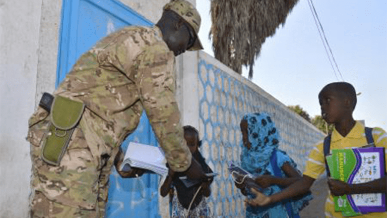 Air Force Staff Sergeant gives school supplies to children in Djibouti