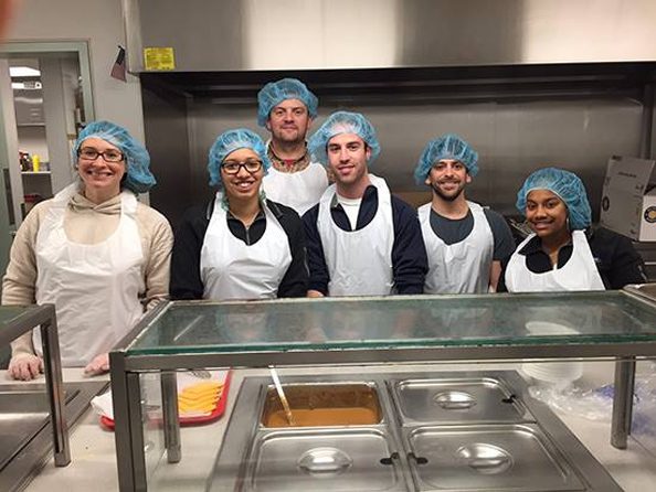 Image of Charles River Analytics team volunteering at food kitchen.