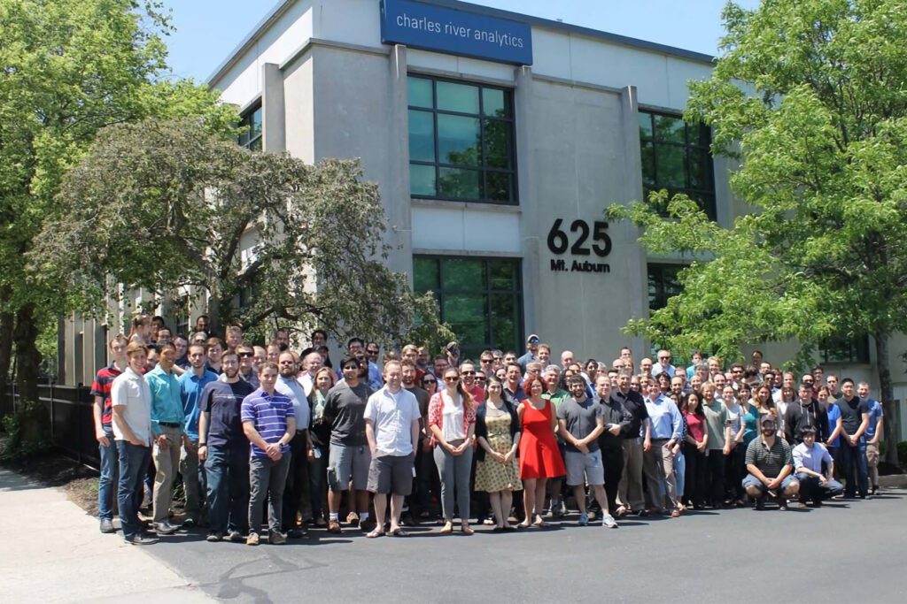Image of Charles River Team standing outside their offices for a company photo. Charles River Analytics, Inc. is proud of their company culture.